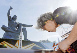 A relative of atomic bomb victims prays at the peace monument in Nagasaki's Peace Park on the 62nd anniversary of the bombing of the city