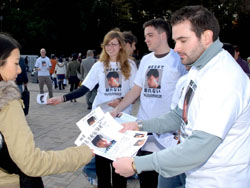Paul Dingwell hands out leaflets Sunday in Tokyo's Harajuku district, urging people to share any information that could lead to the arrest of Tatsuya Ichihashi, who is wanted in the March slaying of Lindsay Ann Hawker