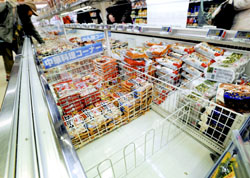 Packages of frozen 'gyoza' dumplings imported from China by JT Foods are removed from a shelf at a
supermarket in the city of Osaka after cases of food poisoning were attributed to the product