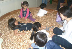 Children play with wooden balls at the Tokyo Toy Museum
