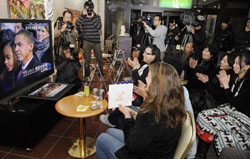 Residents of Obama, Fukui Prefecture, including Americans, cheer as they watch the televised inauguration of Barack Obama