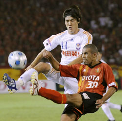 Alessandro Santos and Albirex forward Kisho Yano