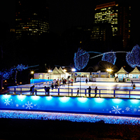 The ice skating rink at Tokyo Midtown is illuminated in the evening.