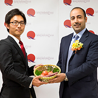 Officials display locally produced vegetables in Kesennuma, Miyagi Prefecture, at a ceremony on the Farming to Regain Livelihood project in October 2014. | QATAR FRIENDSHIP FUND