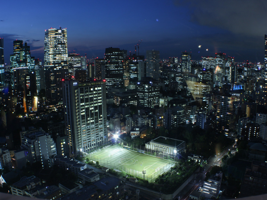Tokyo Tower view of soccer field among skyscrapers